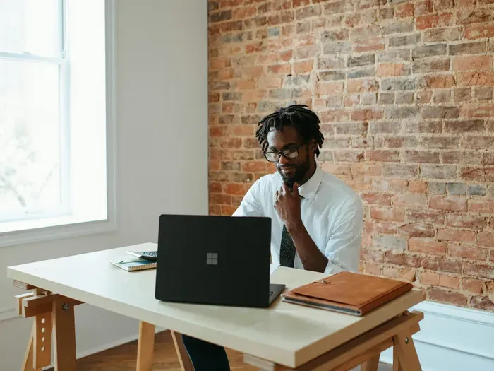 Professional entrepreneur working remotely at a desk with a laptop, highlighting CityBizNet tools for business
